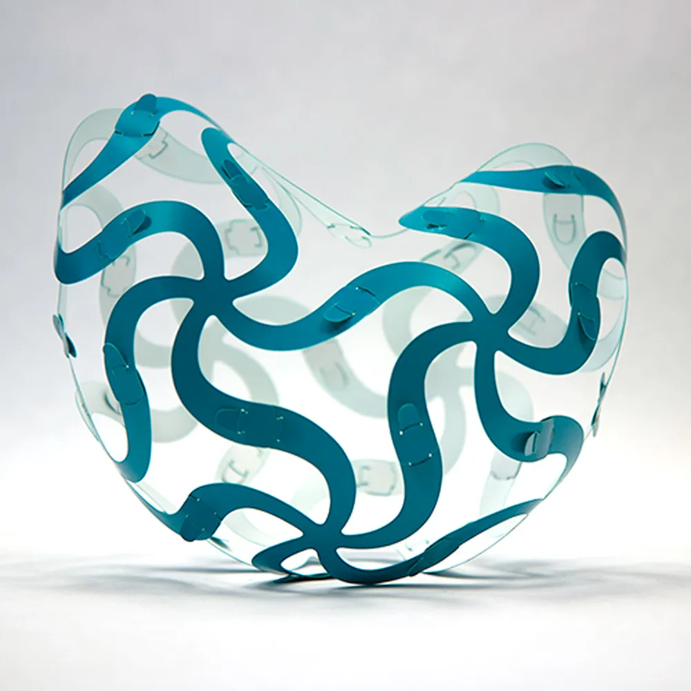 A red and white Curvahedra surface folded into a heart shape with regions of positive and negative curvature.