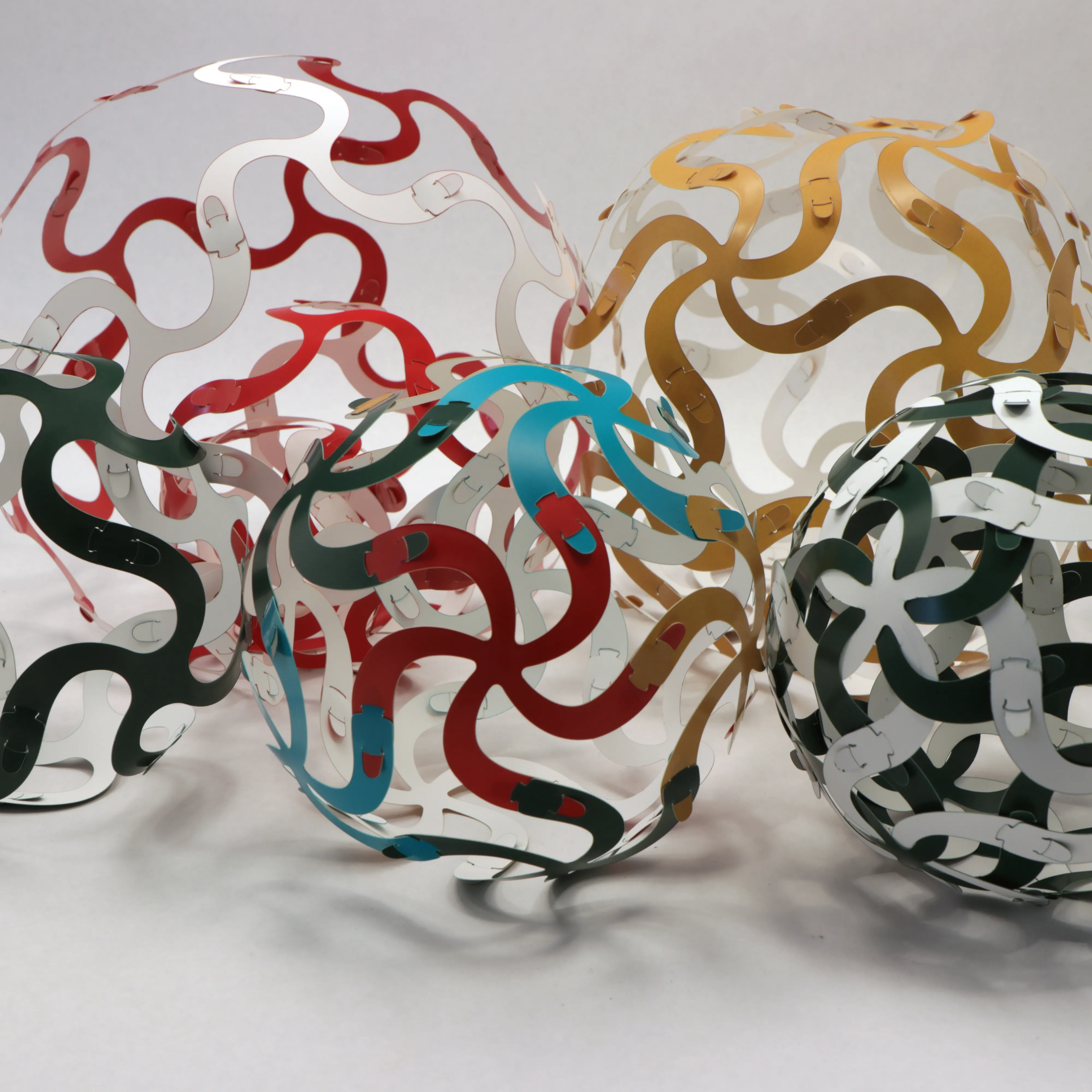 Several Curvahedra models, geometric surfaces made from spiral branching units.
