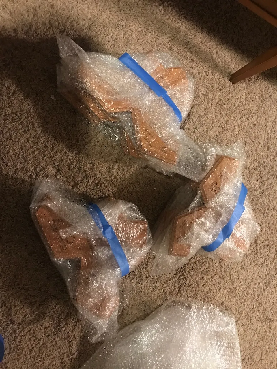Completed plaques bubble-wrapped and taped ready for shipping
