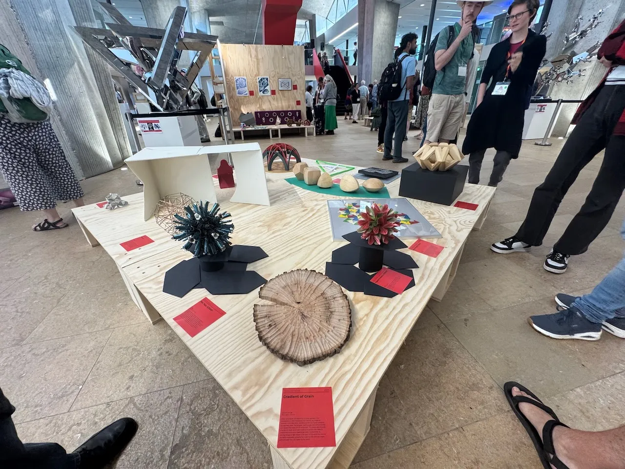 Gradient of Grain on display at a Bridges art exhibition alongside other mathematical artworks, label visible on the plinth