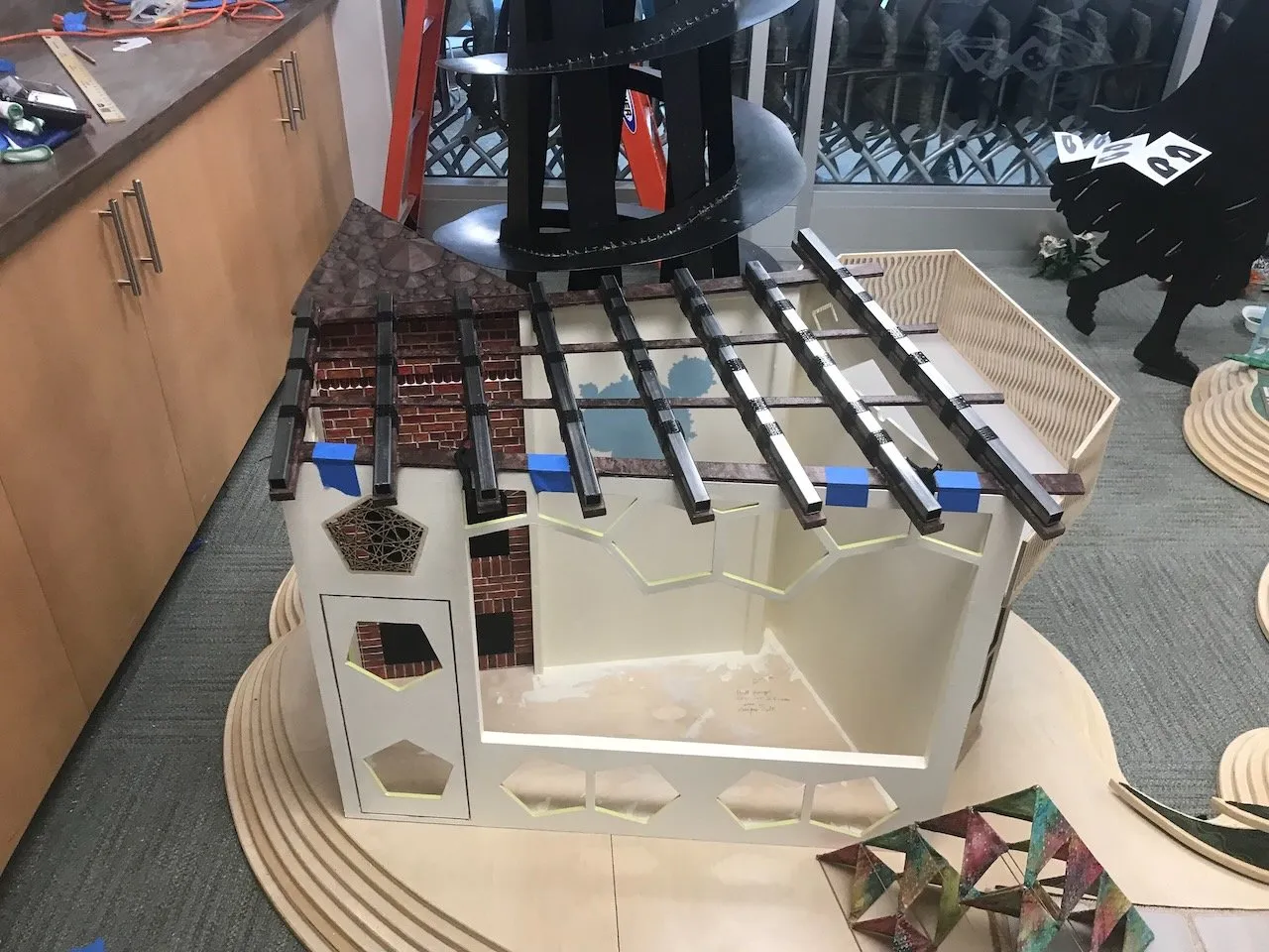 Bakery and Curio Shop section at the Duke assembly; the open grid roof, bay window and pentagon base panels, with colourful Sierpinski triangle pieces leaning against the wall behind
