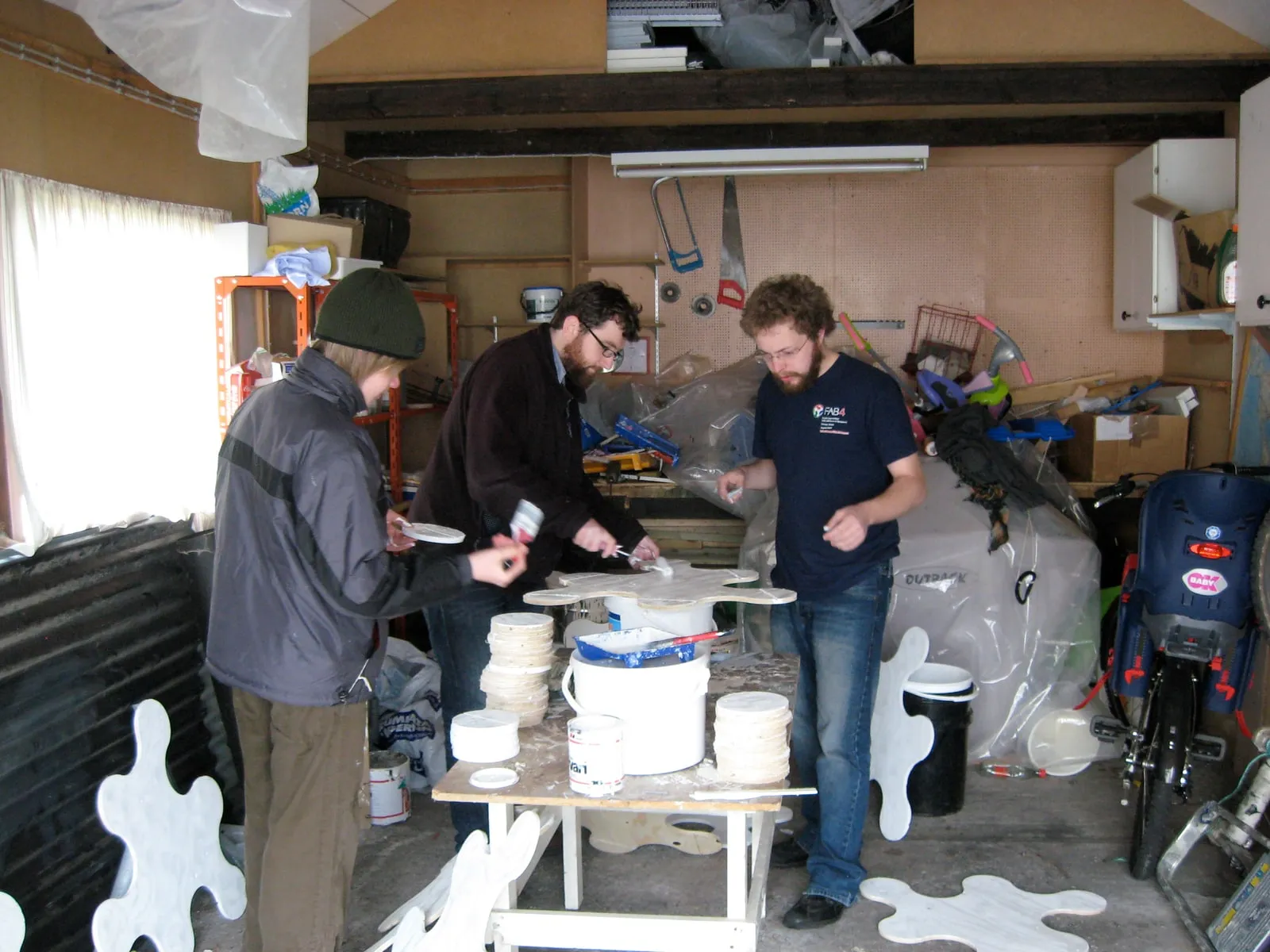 Three people finishing the pieces before heading to the lava field, Heimaey