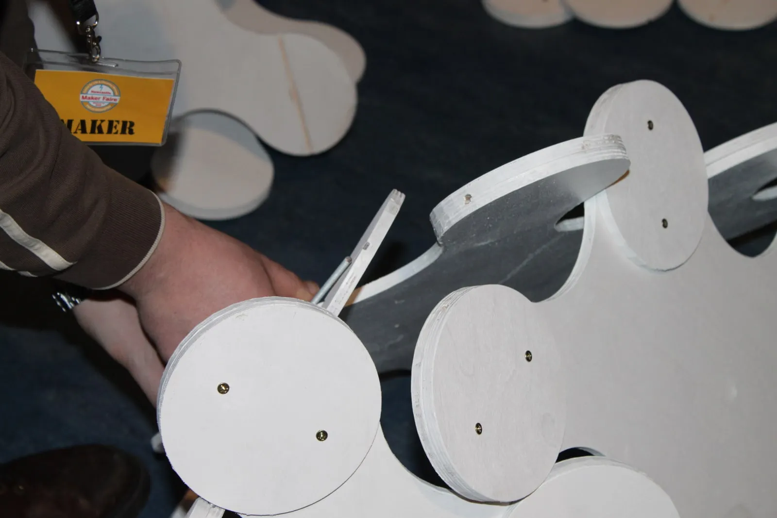 Close-up: inserting the hinge bolt that connects two pieces at the Newcastle Maker Faire build, March 2010