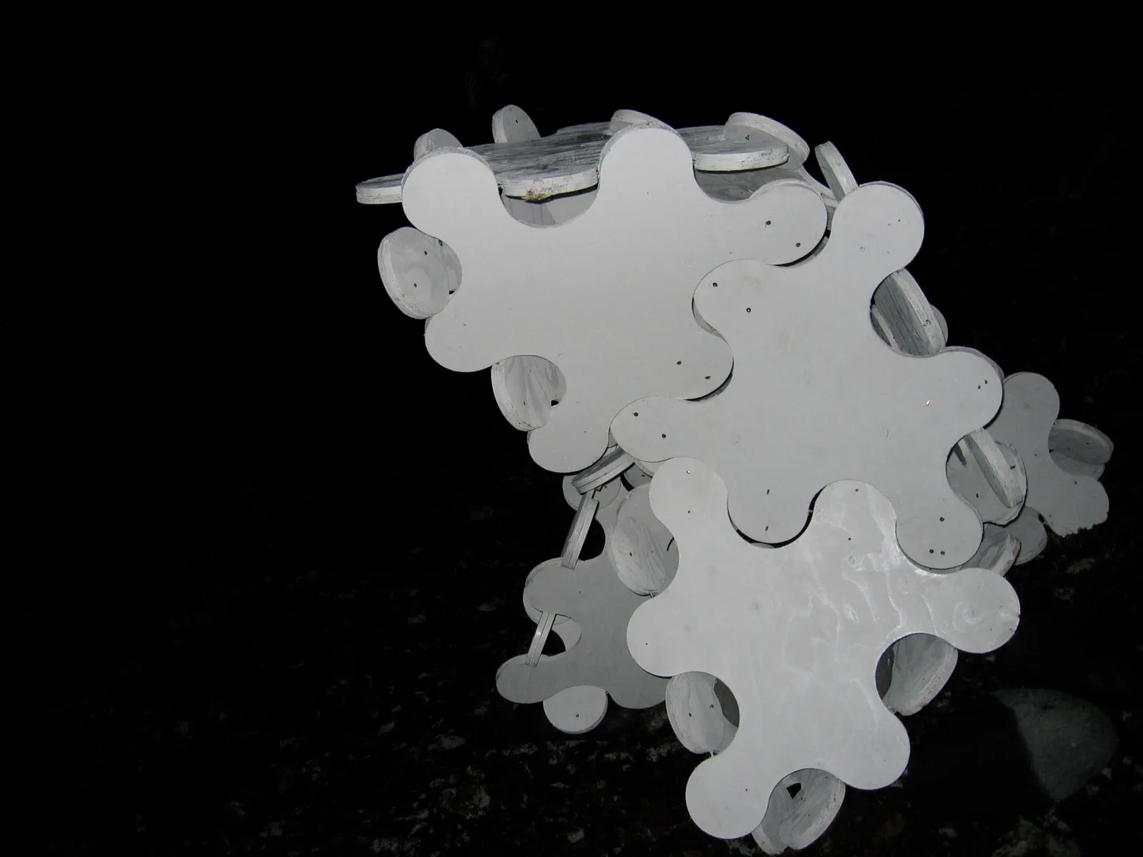 Sculpture System 5 complete on the Eldfell lava field at night, the white form luminous against total darkness